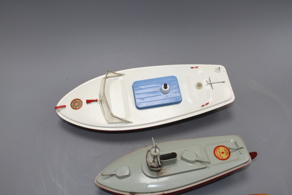 Four Sutcliffe enamelled metal model boats, comprising: two Racer I, both with clockwork, one with key, a Snappy cruiser and a Merlin